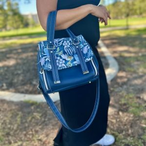 Blue vadon bag with autralian blue banskia feature fabric worn over the arm