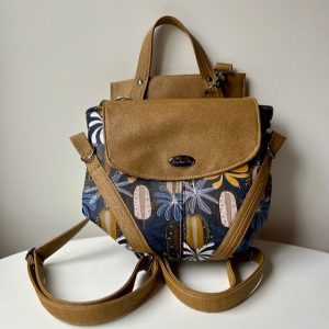 Sand and navy blue backpack featuring Australian banksia print material